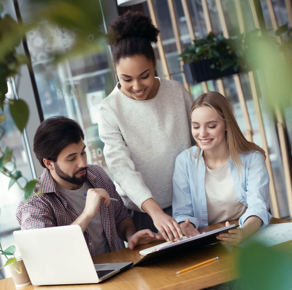 a group of people working on a laptop